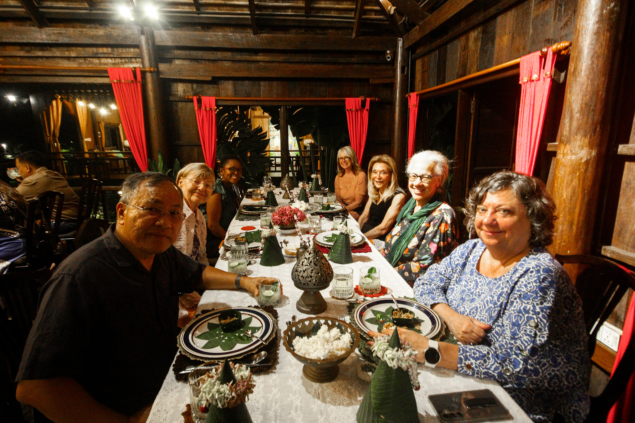 Audience at a panel discussion event on Cambodia's digital future, seated facing a stage with a speaker at a podium and large screens displaying panel information.