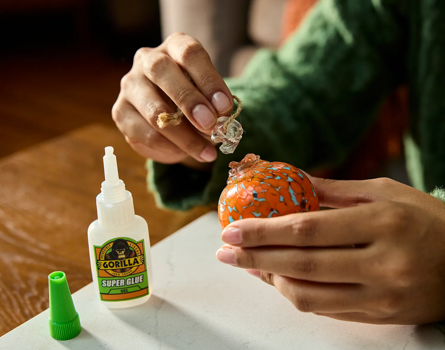 Home repair solution image demonstrating Gorilla Super Glue fixing a broken glass ornament.