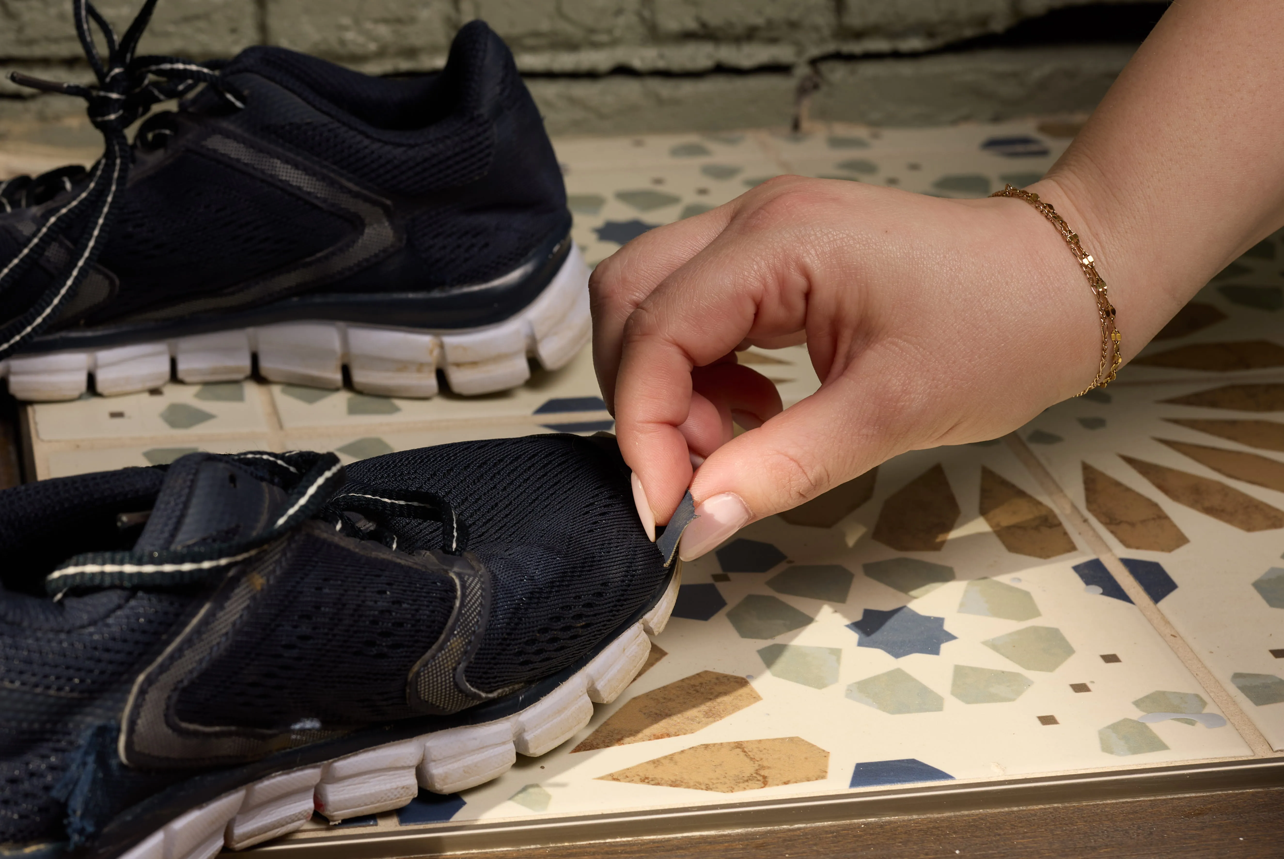 Worn shoe with torn toe area.
