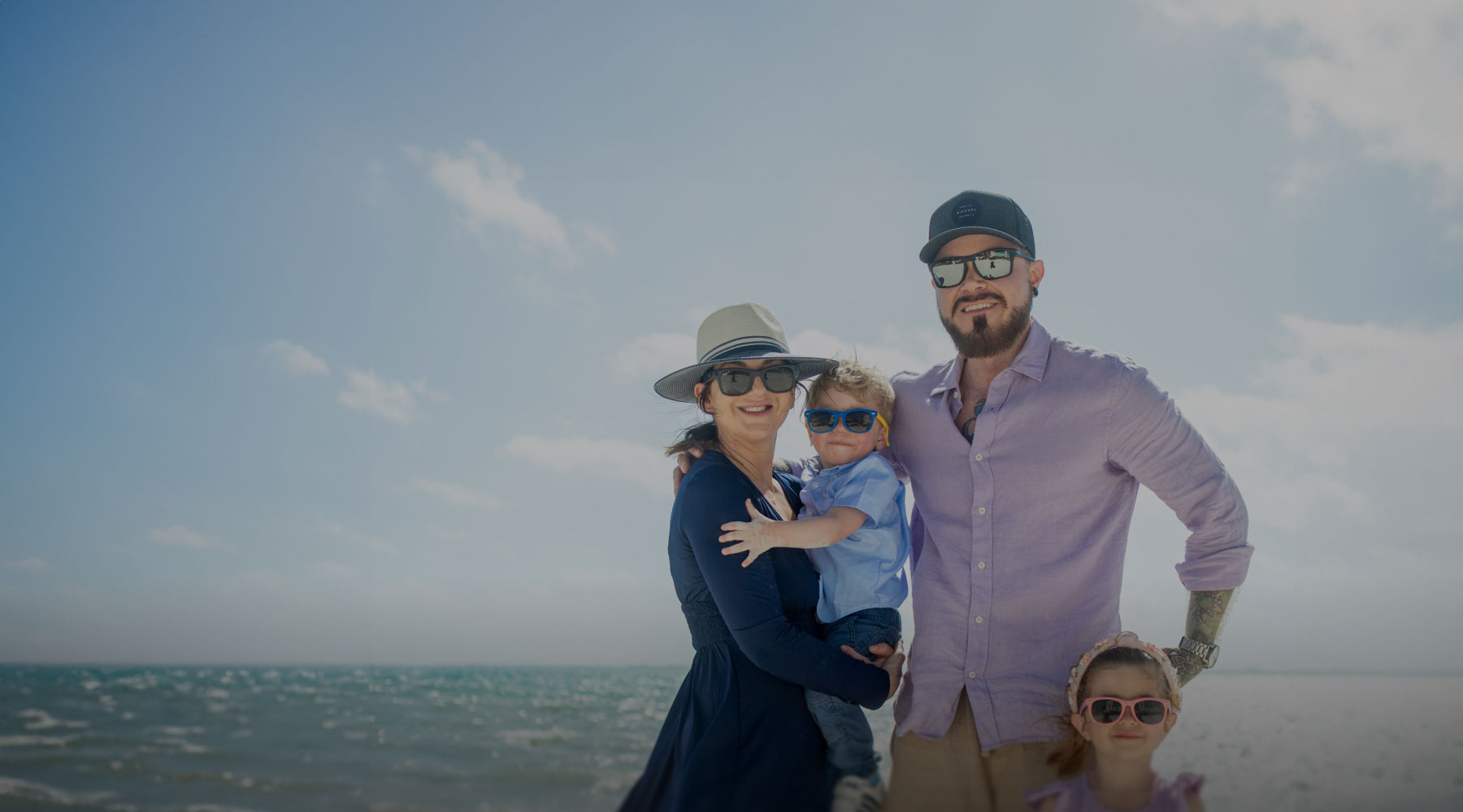 Pamela Garrett holding son with husband and daughter on the beach