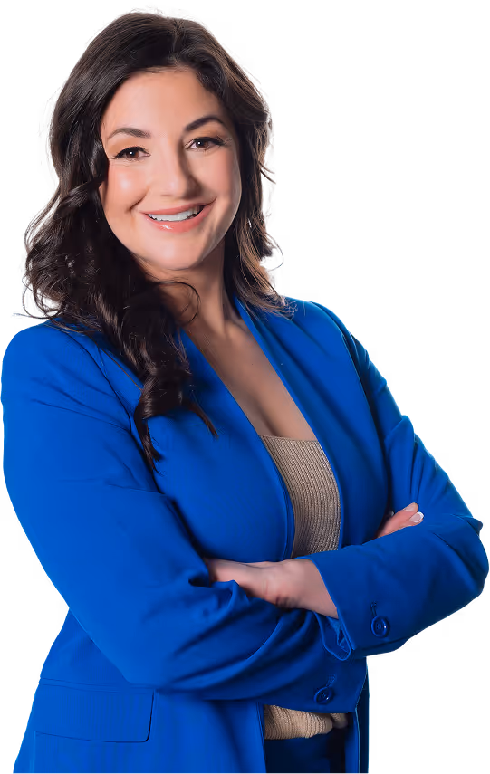 Pamela Garrett in a blue suit, smiling with arms crossed