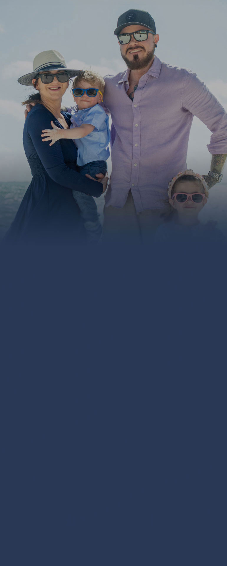 Pamela Garrett holding son with husband and daughter on the beach