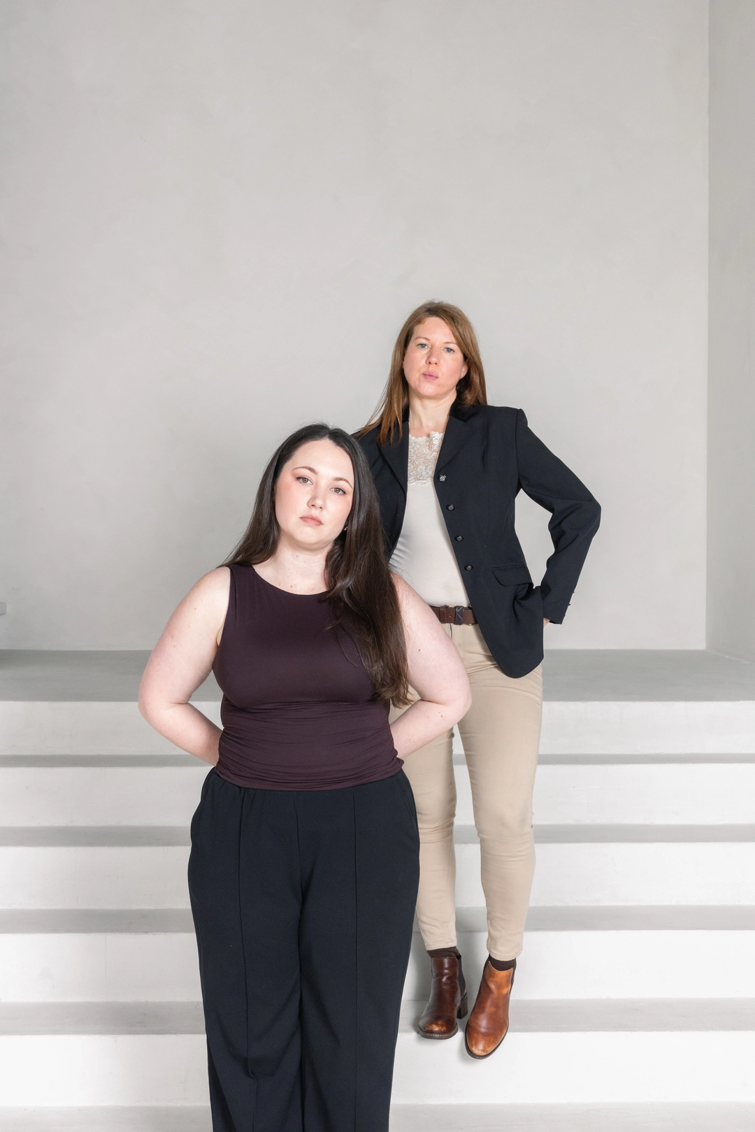 Adcraft Studio team members working together against a textured grey studio wall.