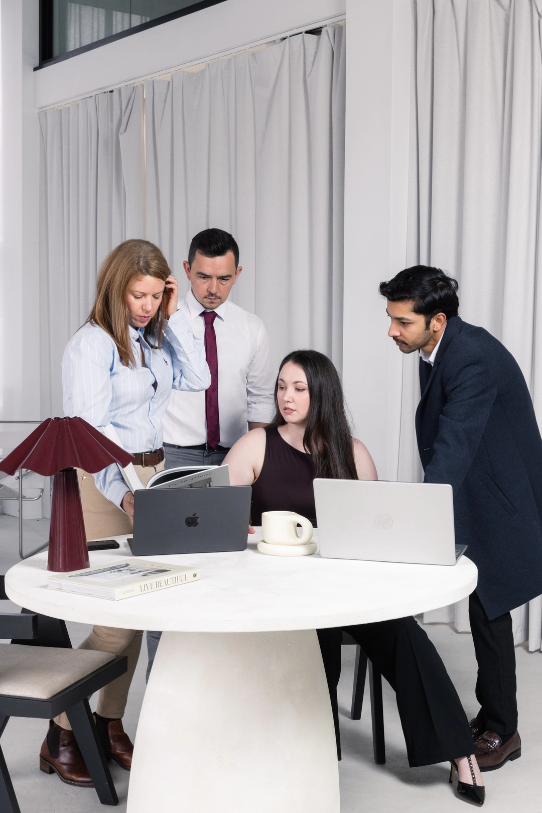 The Adcraft Studio team collaborating on a laptop in their Wollongong studio.