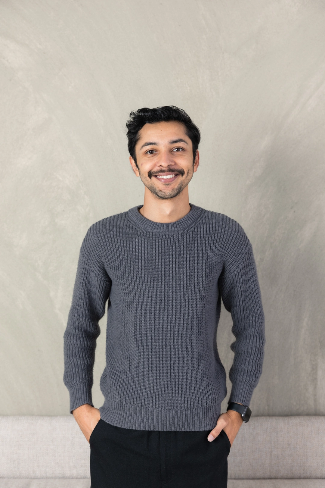 Aman Hirani, website director at Adcraft Studio, smiling in the Wollongong studio.