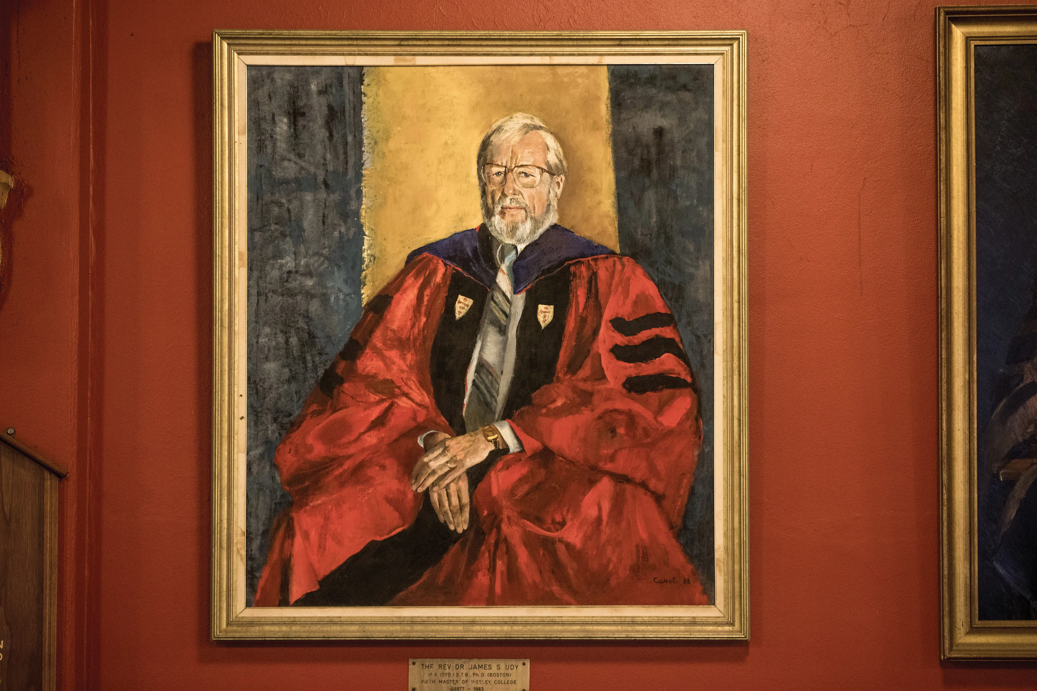 Portrait painting of a man with white hair and beard wearing glasses and a red academic robe with black stripes.