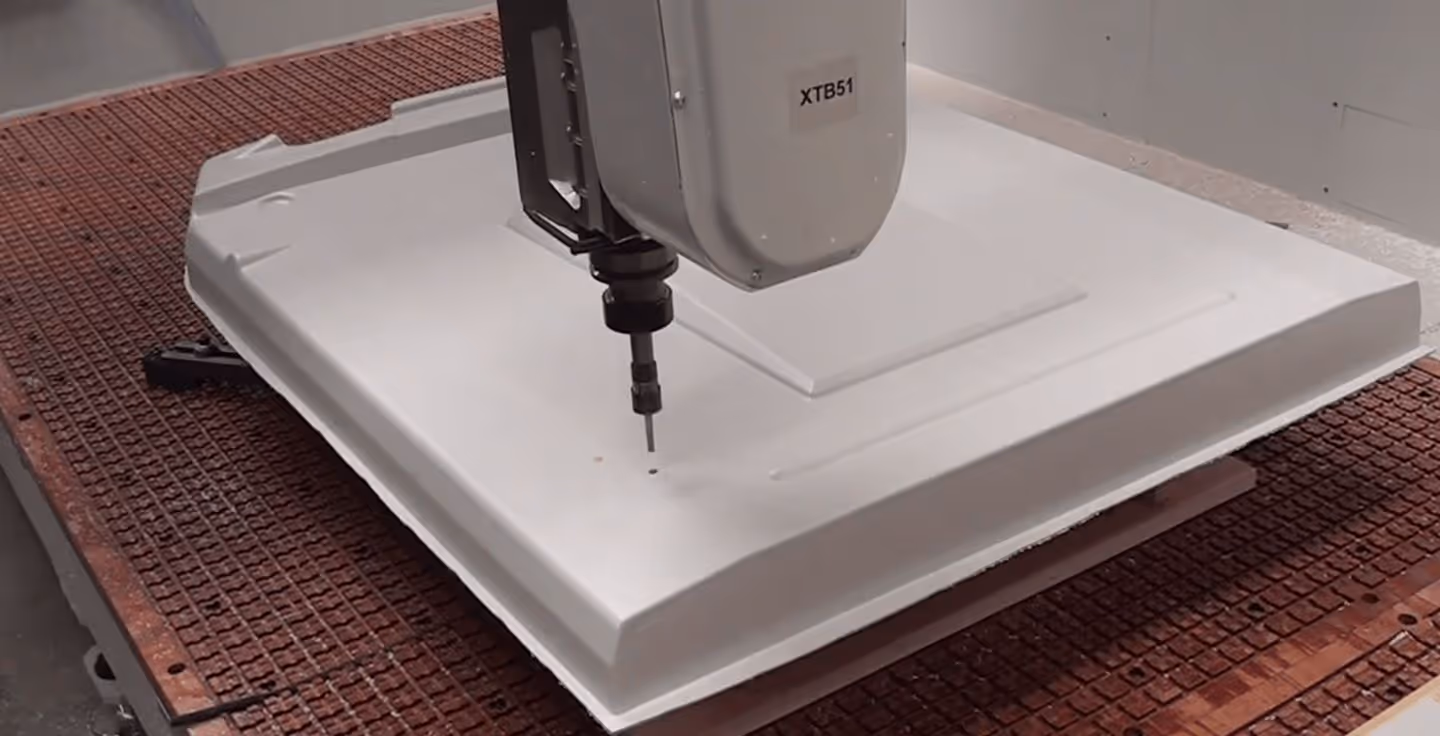 A white box with a machine on top of it.