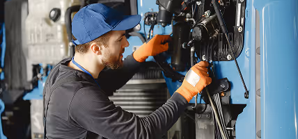 A man working on a machine in a factory.