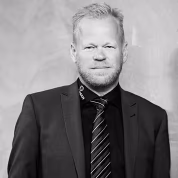 A black-and-white photo of a man in a suit.