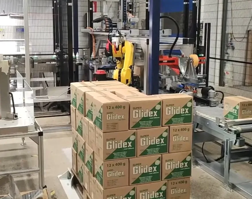 Robot stabler papkasser på palle i Gibotechs pakkeanlæg til Unipak