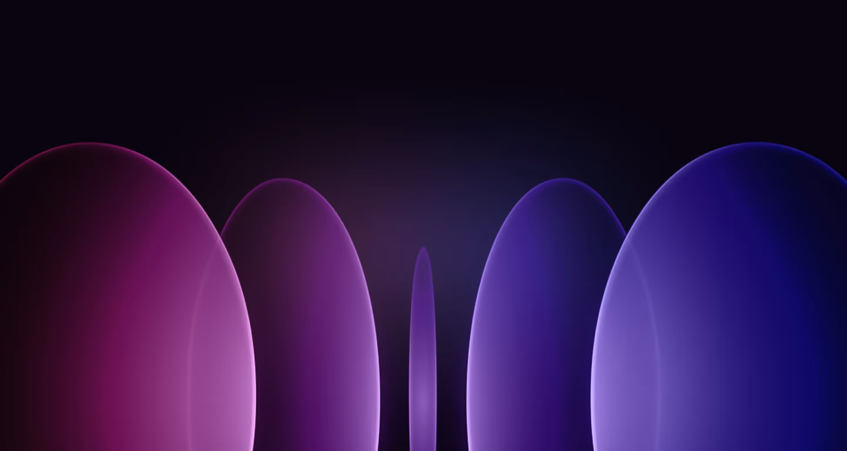 round plastic slides in a gradient from blue to pink hang in the air