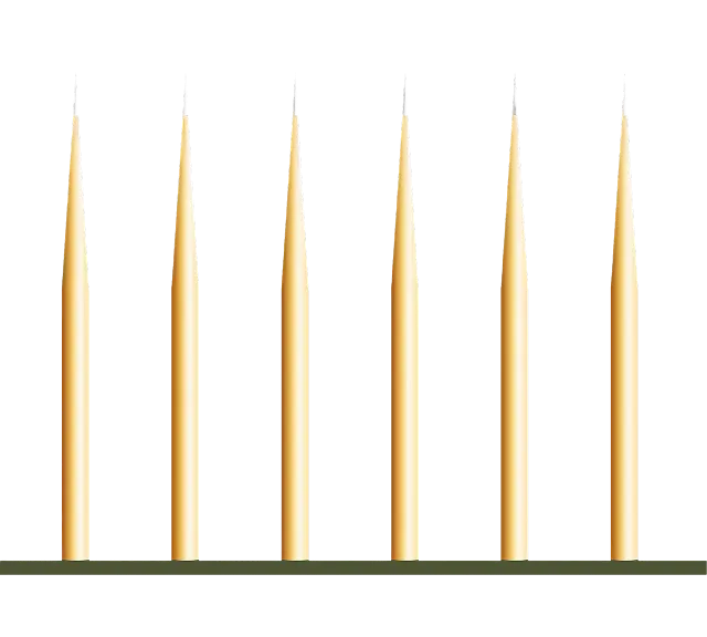 A row of candles sitting on top of a shelf.
