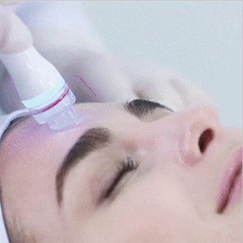 A woman is getting her hair brushed by a hair dryer.