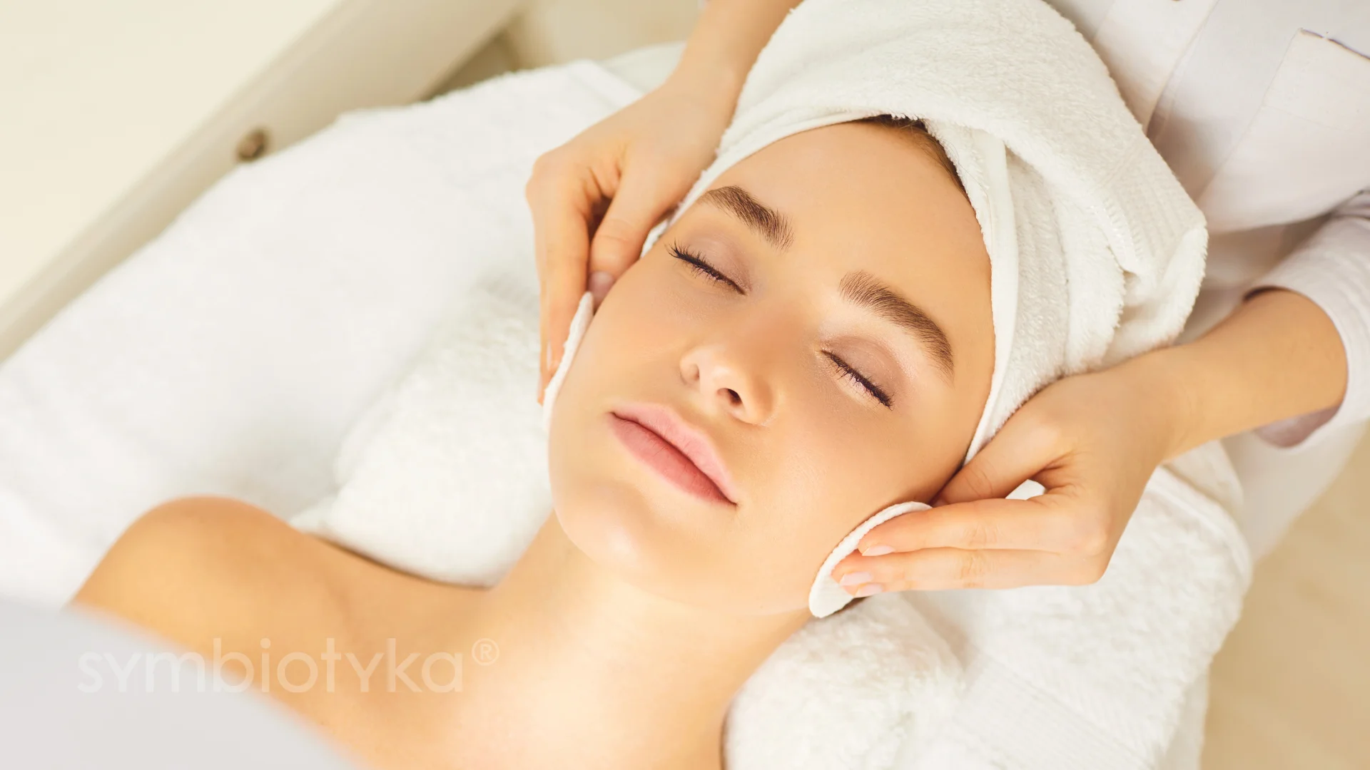 A woman getting a facial massage at a spa.