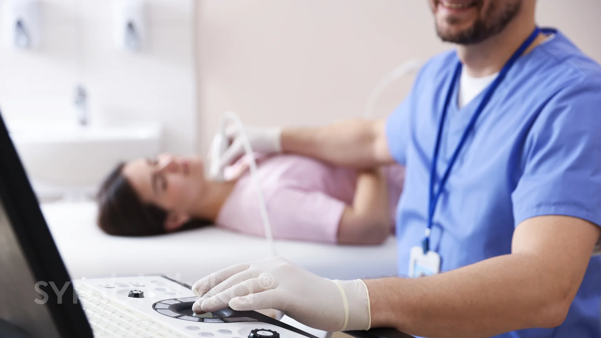 Healthcare professional performing an ultrasound scan on a female patient lying down.