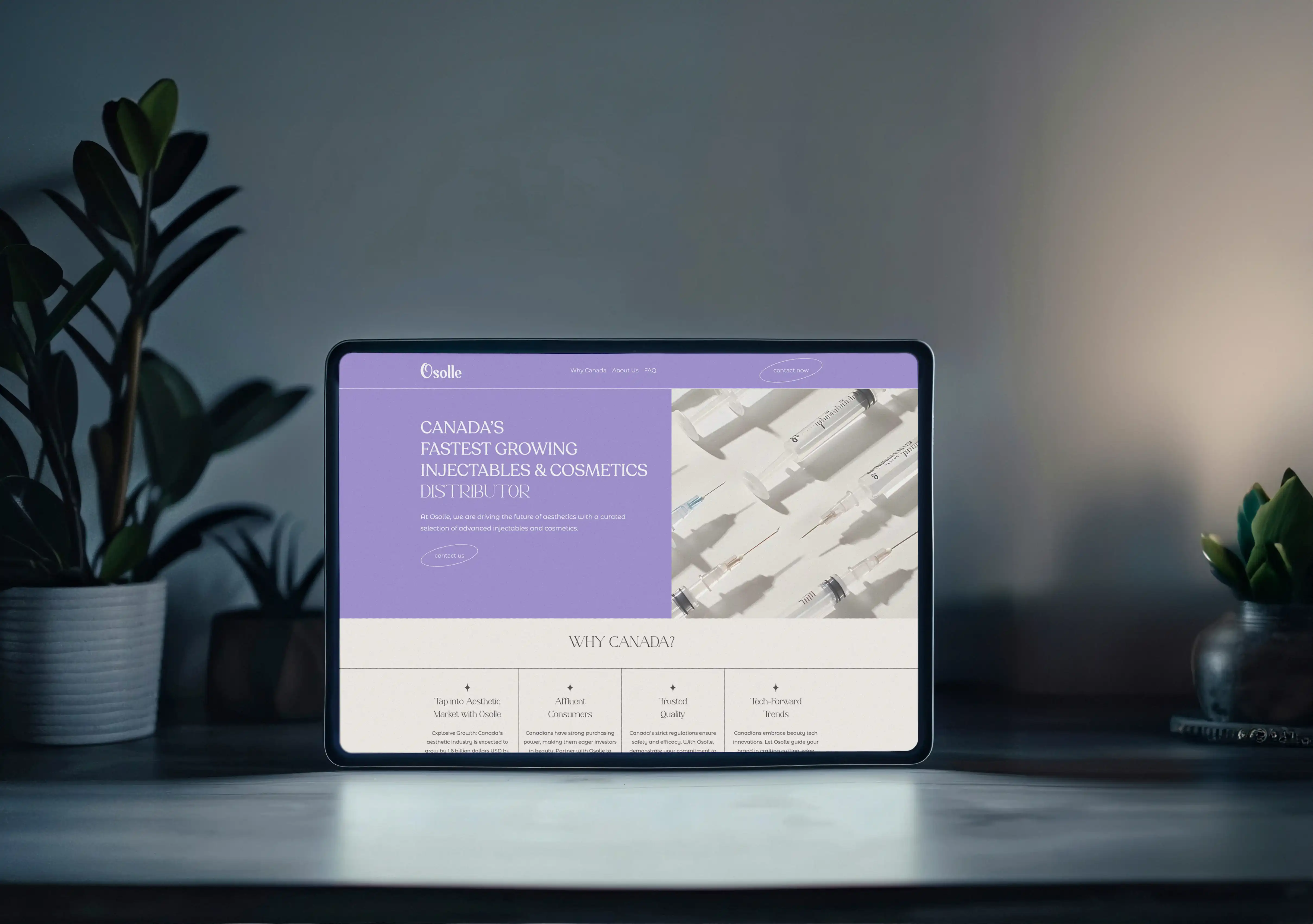 Tablet on a desk displaying a website for Osolle, Canada's fastest growing injectables and cosmetics distributor, with images of syringes and text about Canadian market advantages.