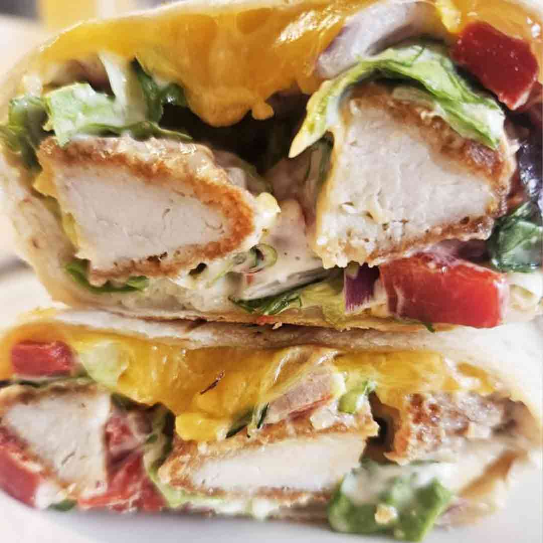 A delicious Roots Chicken Goujon wrap cut in half