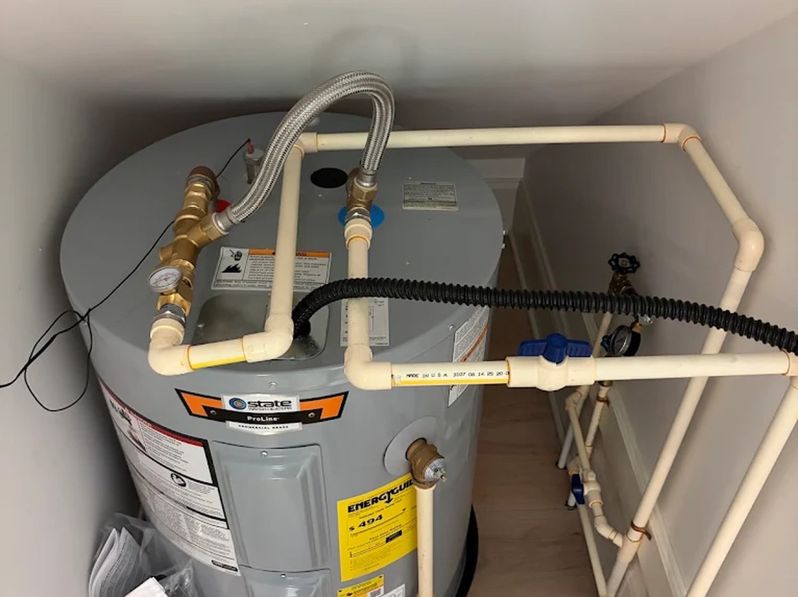 Residential electric water heater and connected supply piping