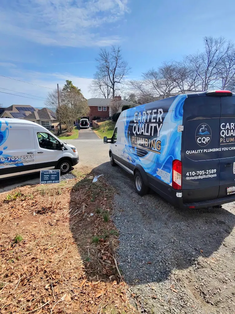 Carter Quality Plumbing service vans parked at a home