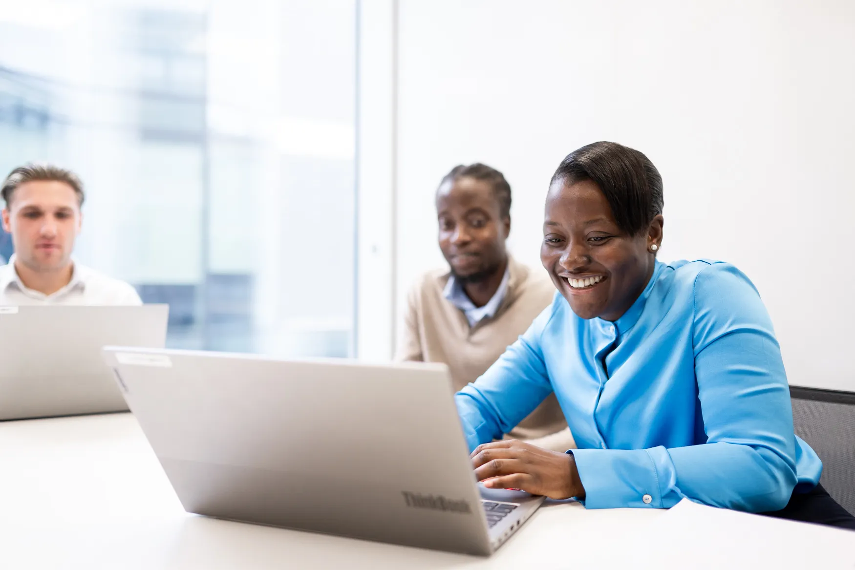 Langham Hall employees working on a laptop