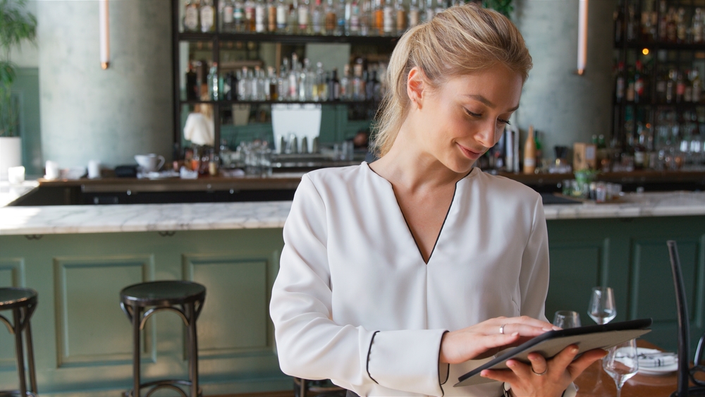 Restaurant manager using a tablet