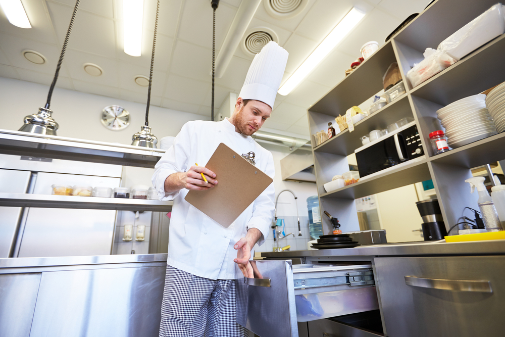 A chef manually checking inventory levels