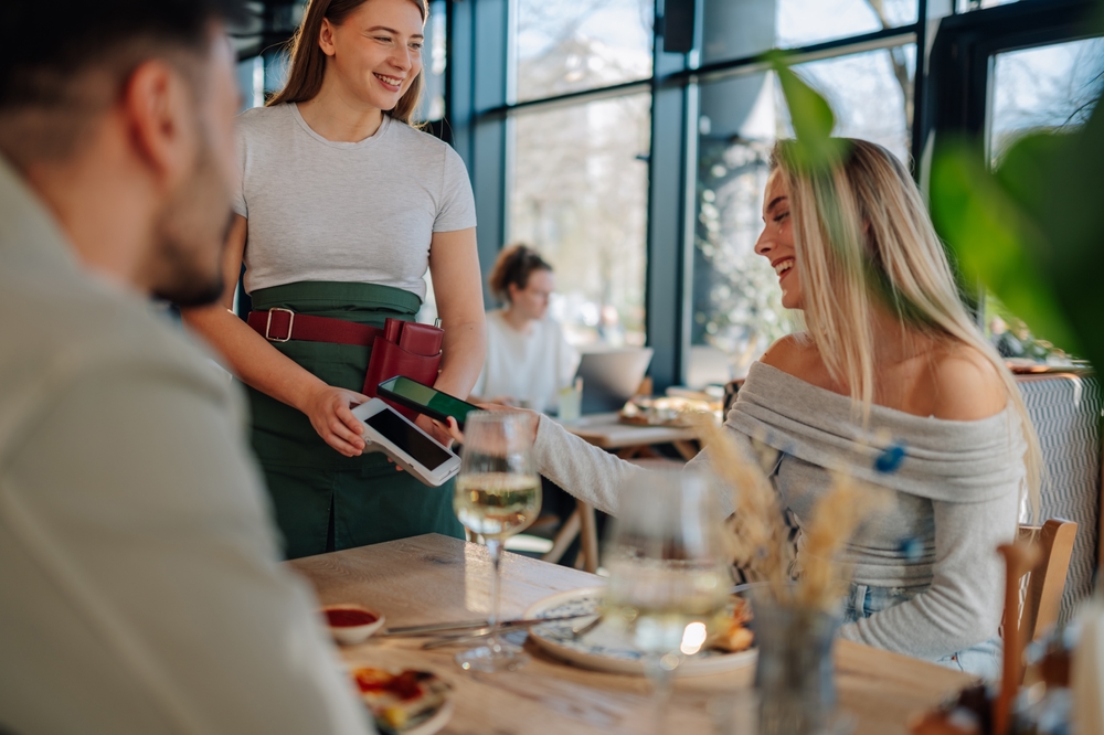 A customer making contactless payment at a restaurant