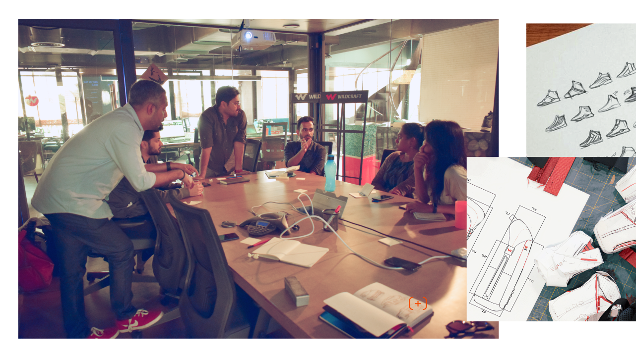 A founder and design team working through sketches around a table