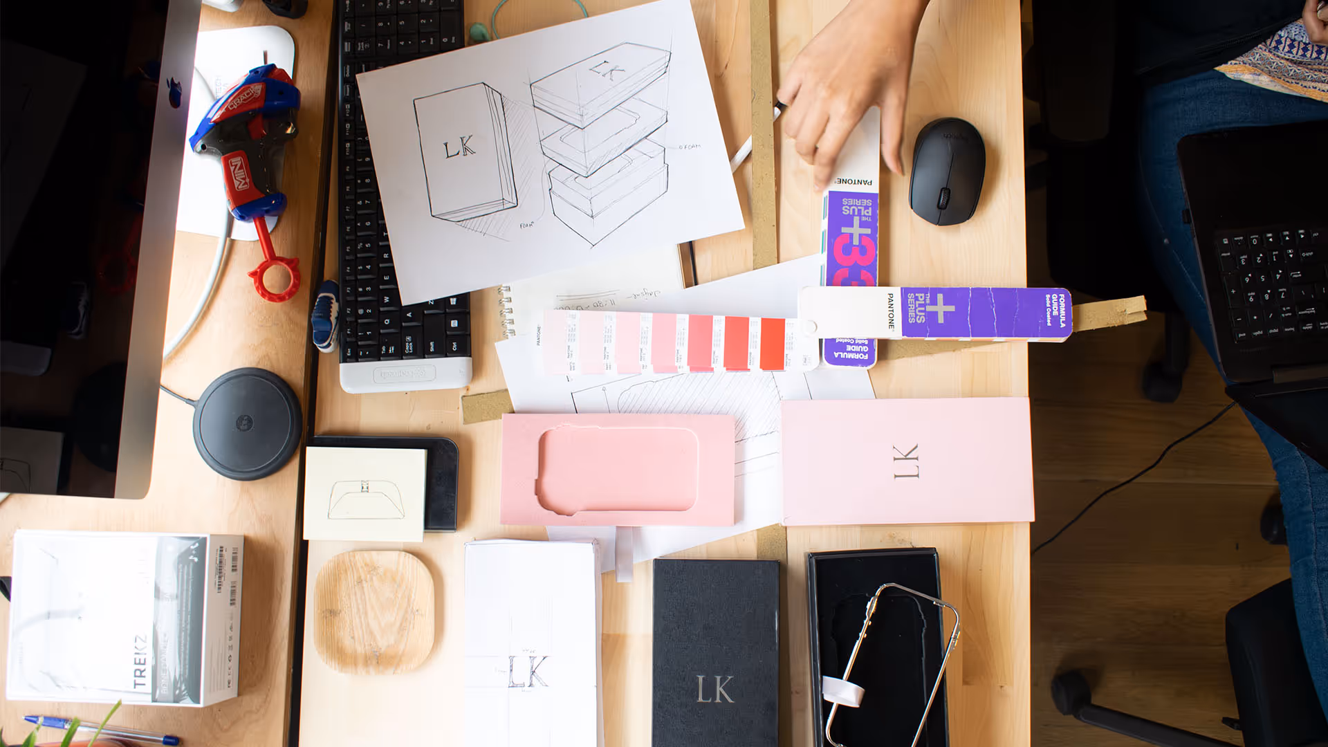 Desk with design sketches, color swatches and phone case molds