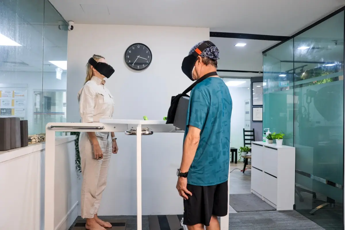 Patients standing on specialized platform testing equipment for automated NeuroPosture Calibration and balance tracking.