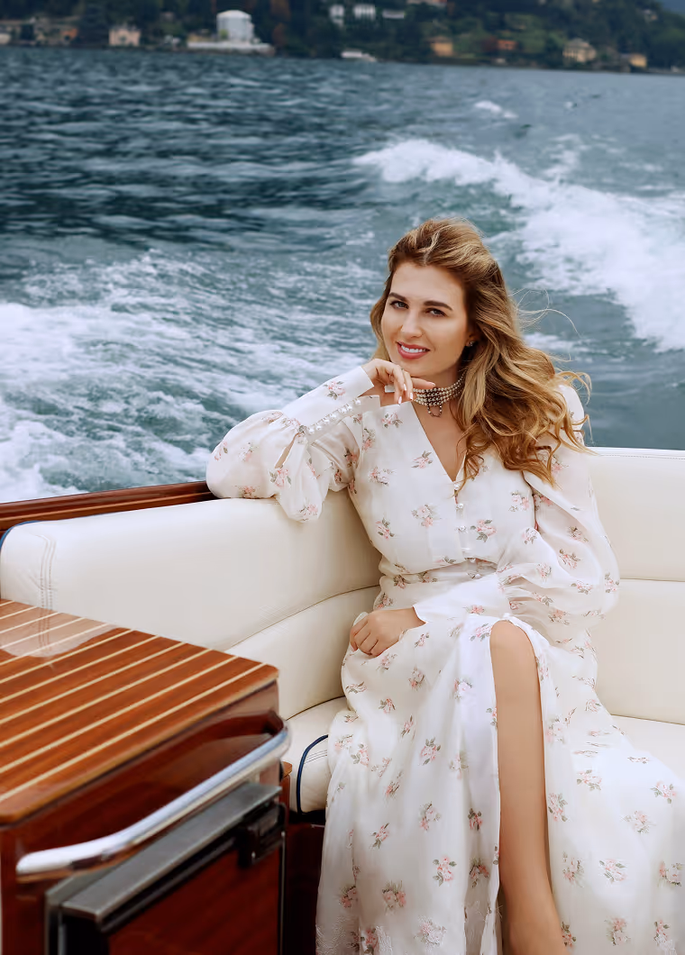 Women's photoshoot on a wooden boat on Lake Como, Italy