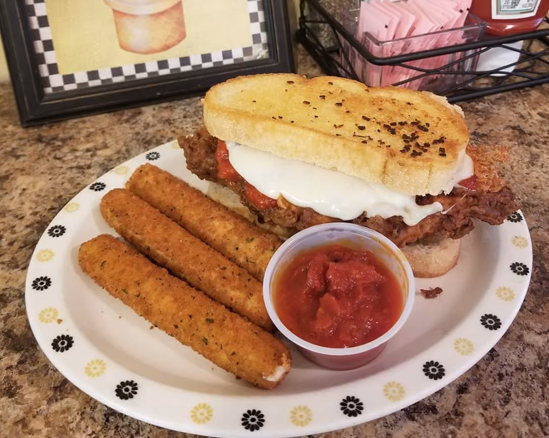 A plate featuring a sandwich alongside a serving of golden fries.