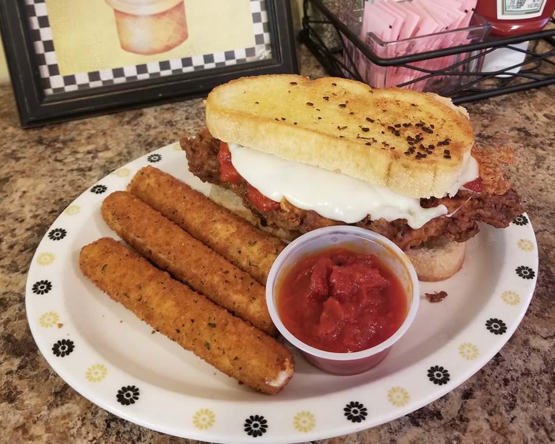 A plate featuring a sandwich alongside a serving of golden fries.