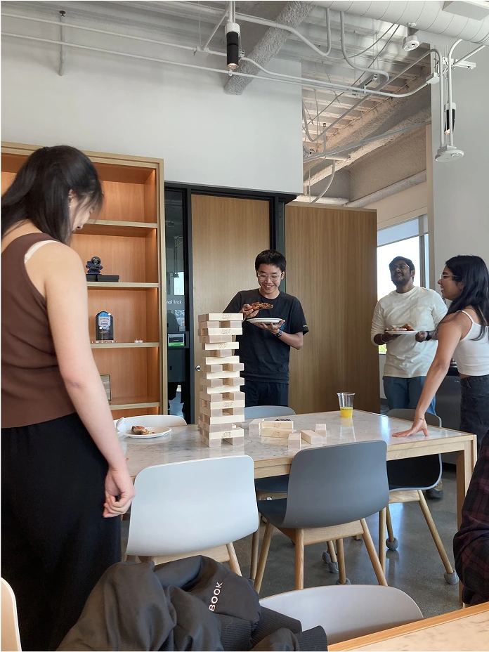 Moloco interns playing Jenga and eating pizza. 