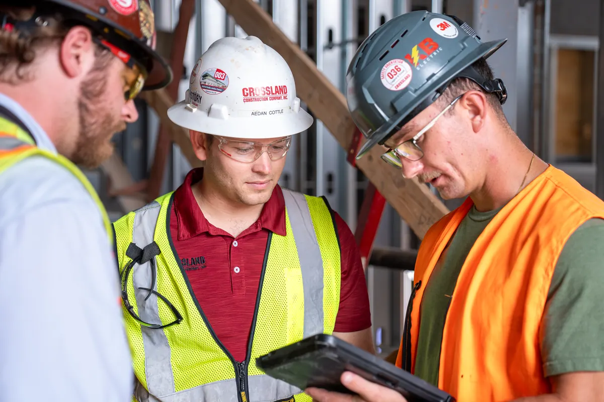 KB Electric electrician reviewing plans with the general contractor on a commercial job site