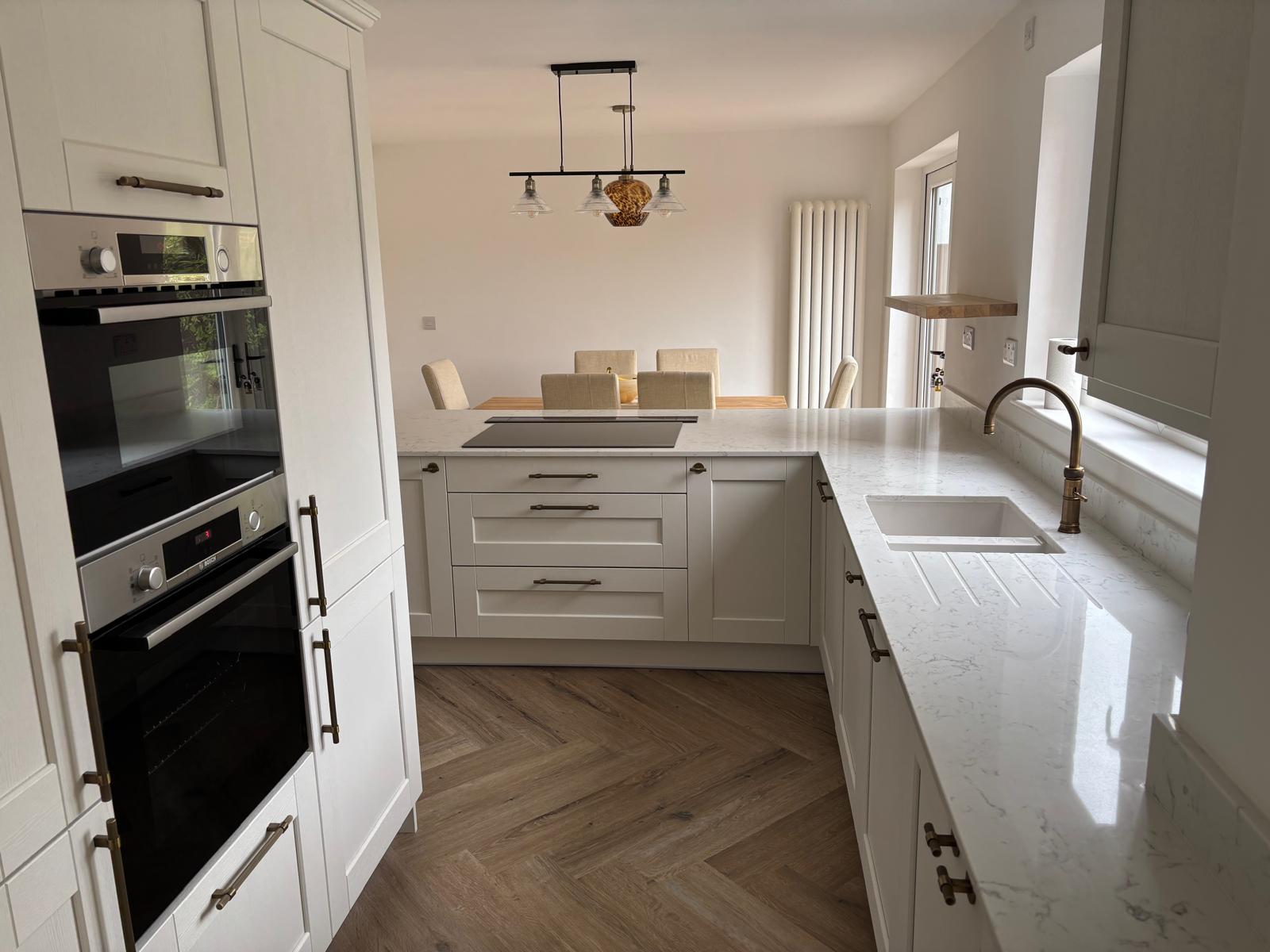 After renovation modern white kitchen with quartz worktops and integrated appliances – Project Managed Kitchens West Midlands