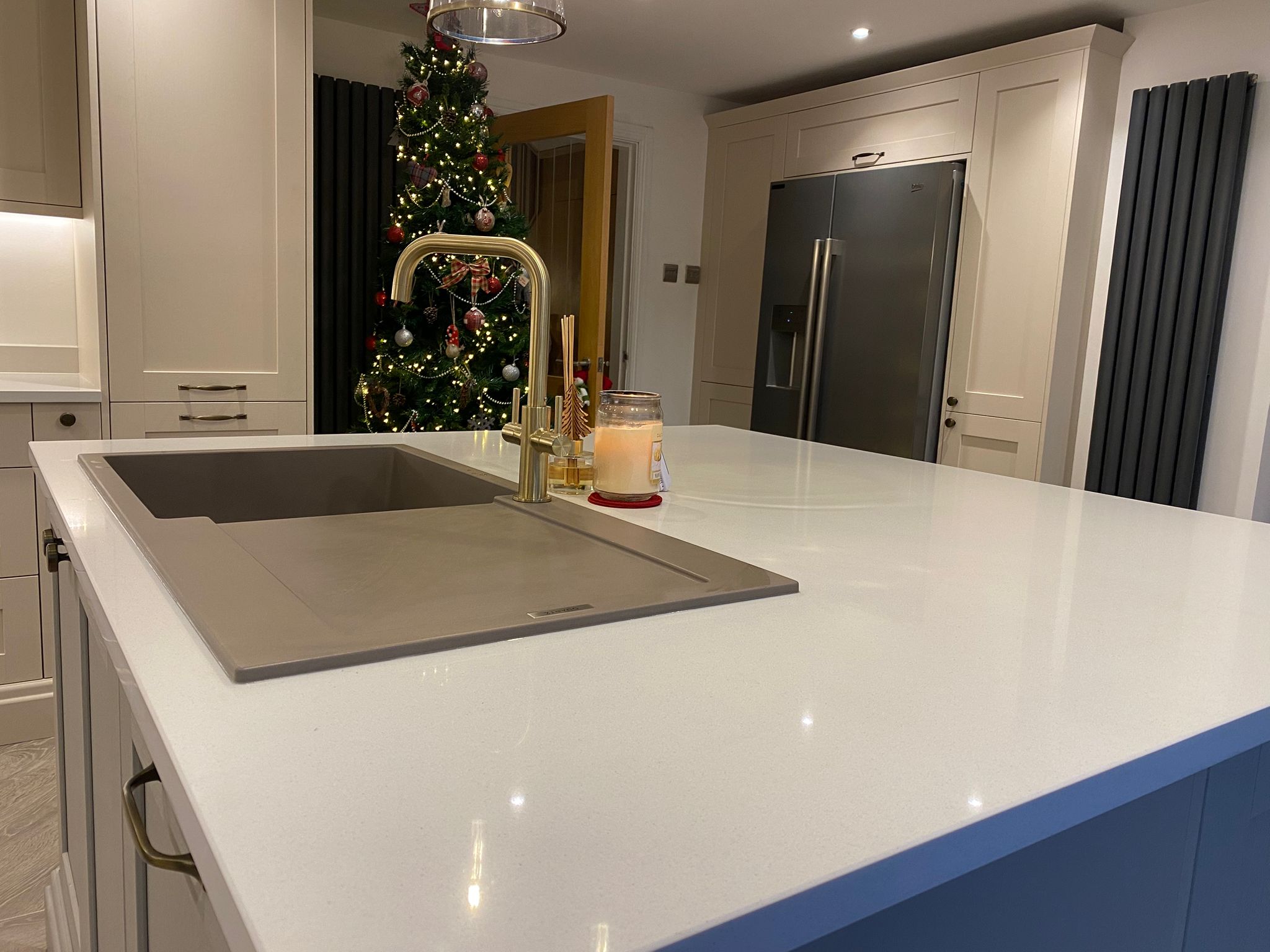 Modern quartz kitchen island with gold tap and integrated sink – Project Managed Kitchens renovation.
