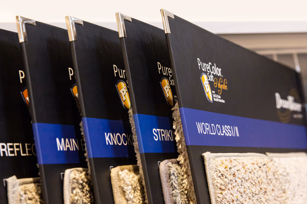 Rack cards displaying PureColor Soft carpet samples with labels like World Class II and Striking.