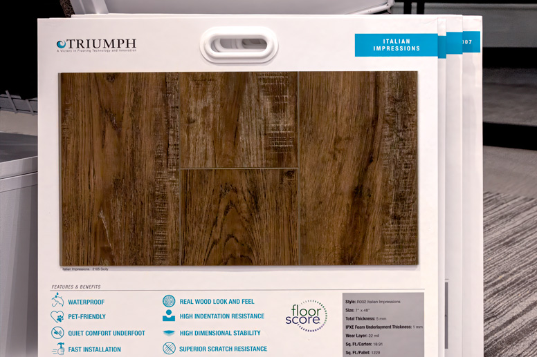 Sample display cards showing brown wood-look flooring with features like waterproof and scratch resistance.