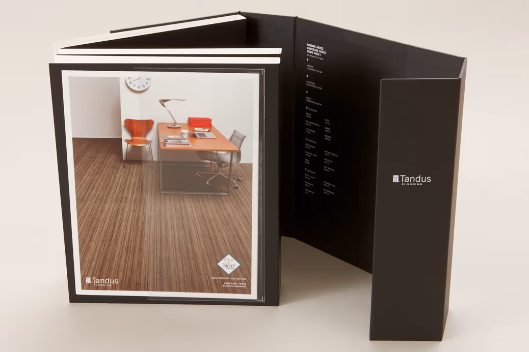Sample book set by Tandus Flooring showing carpet designs in a black folding display.
