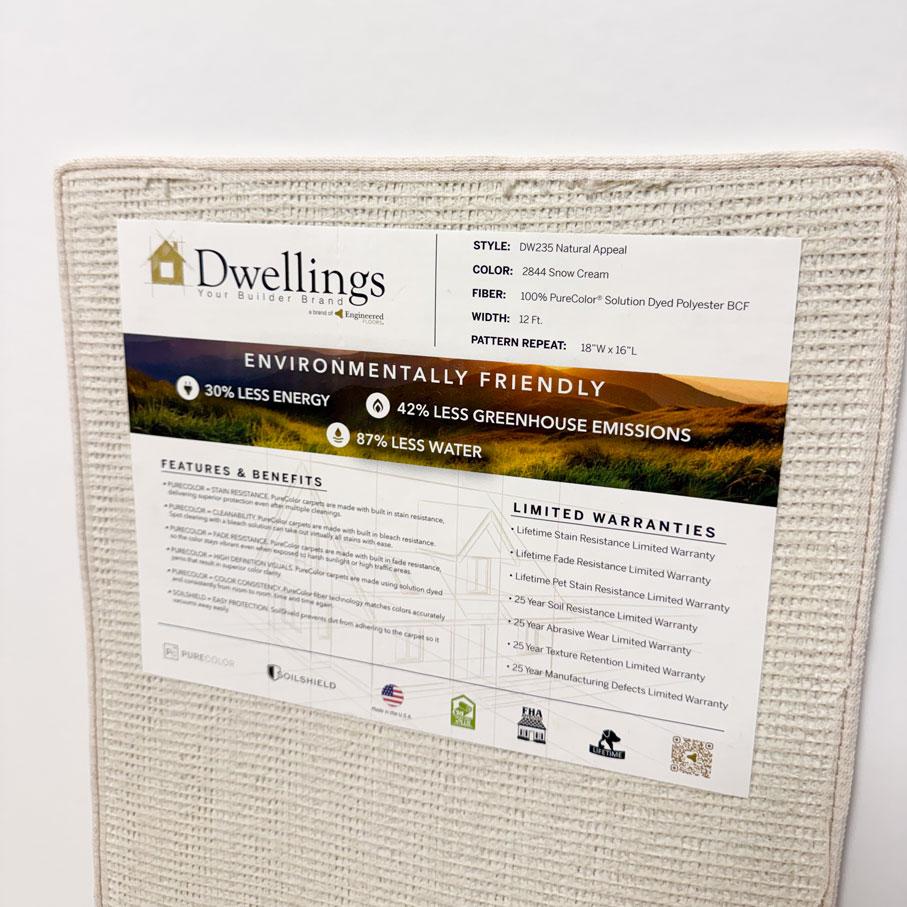 Dwellings rug label showing style, color, fiber, width, pattern repeat, eco benefits, features, and warranties.