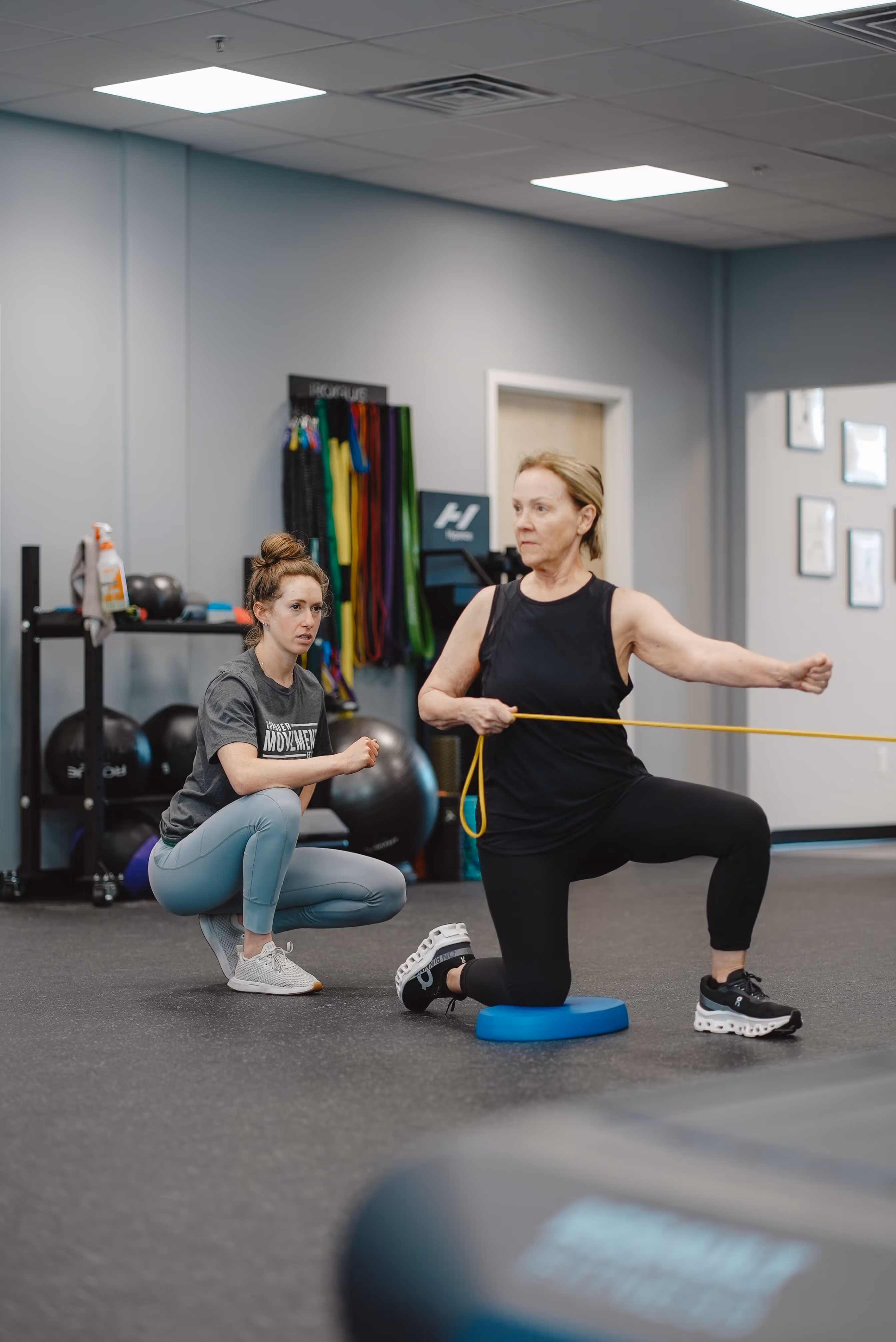 Physical therapist assessing back mobility and posture during evaluation in Wilmington, NC