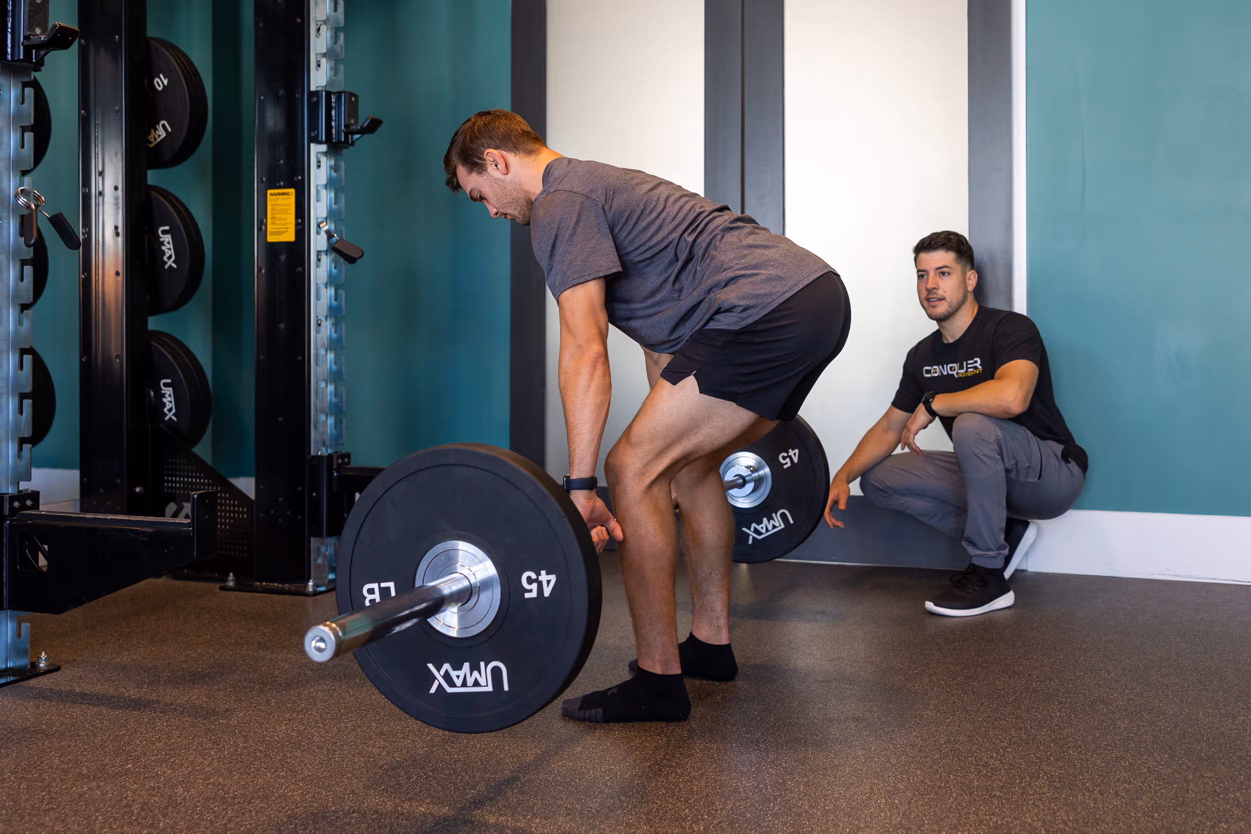 Physical therapist evaluating knee mobility and strength during session at Wilmington NC clinic