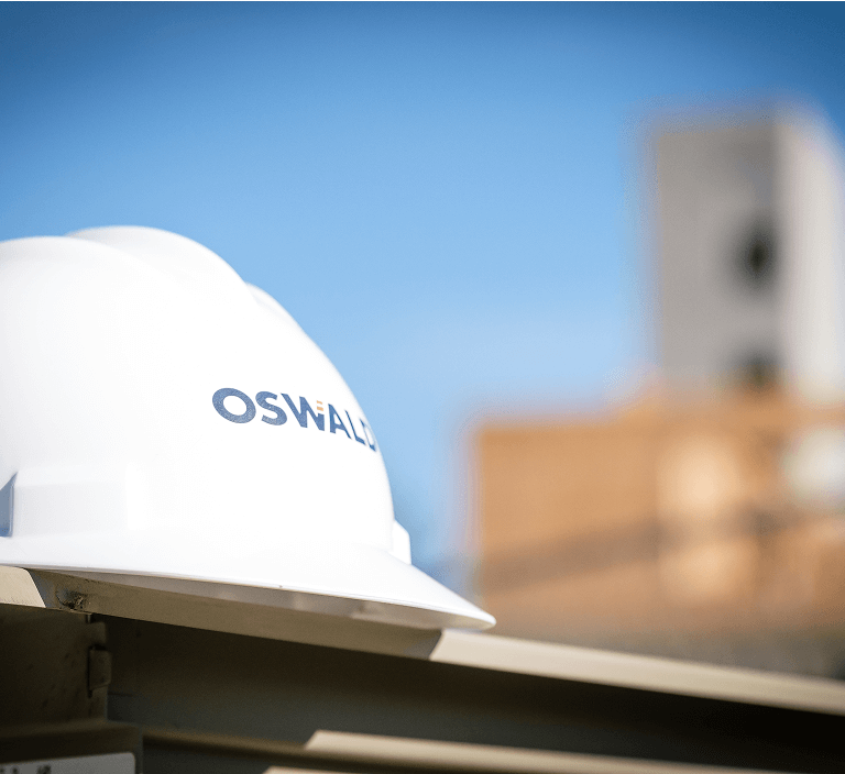A white hardhat with Oswald logo.