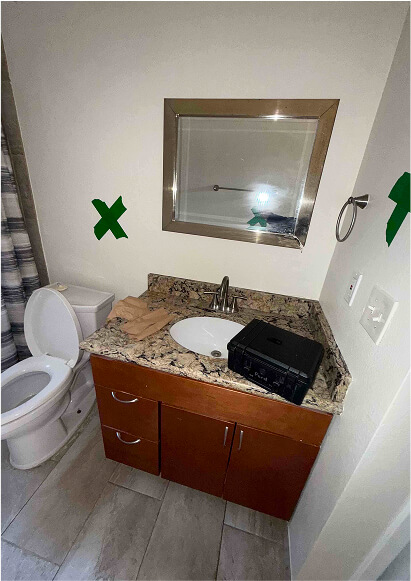 Restored bathroom with vanity, mirror and toilet after mold remediation
