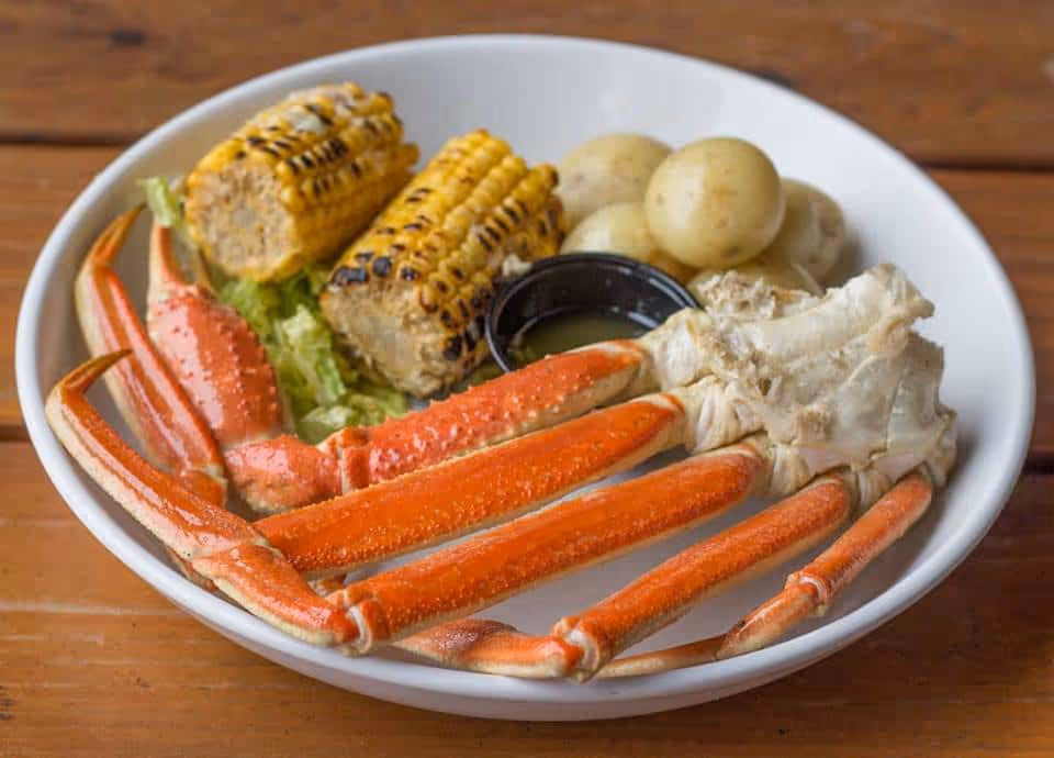 Crab legs with potatoes and corn.