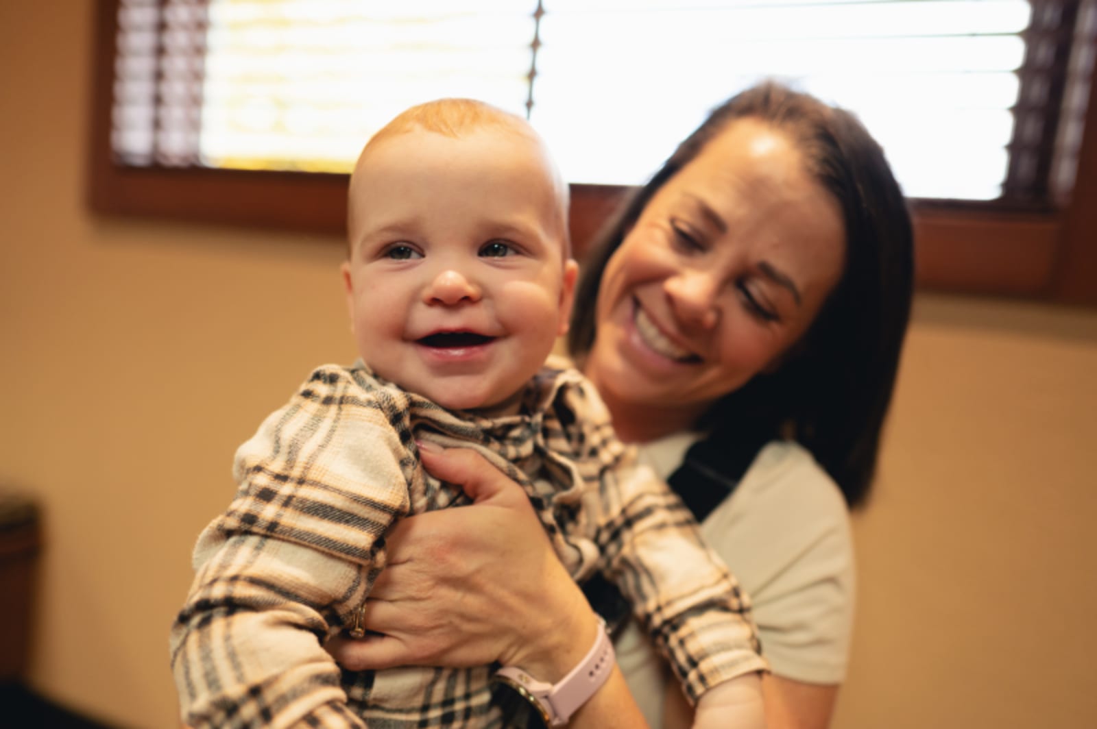 Dentist talking with a toddler and parent in the operatory, building comfort and trust