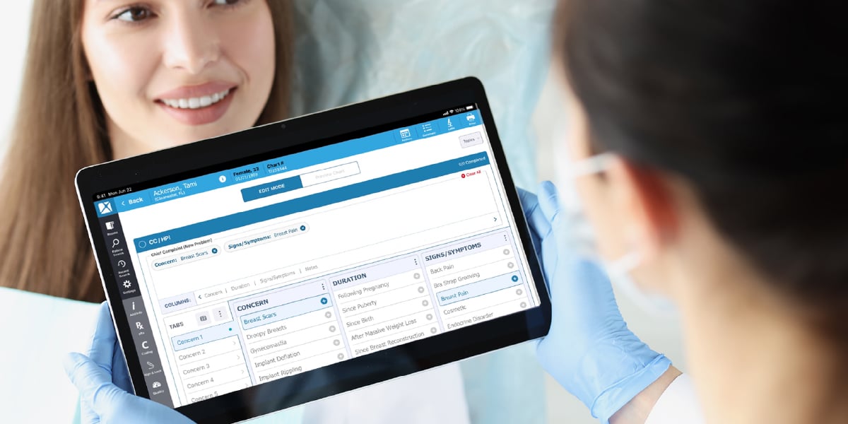 Medical professional in gloves holding tablet showing electronic health record interface.
