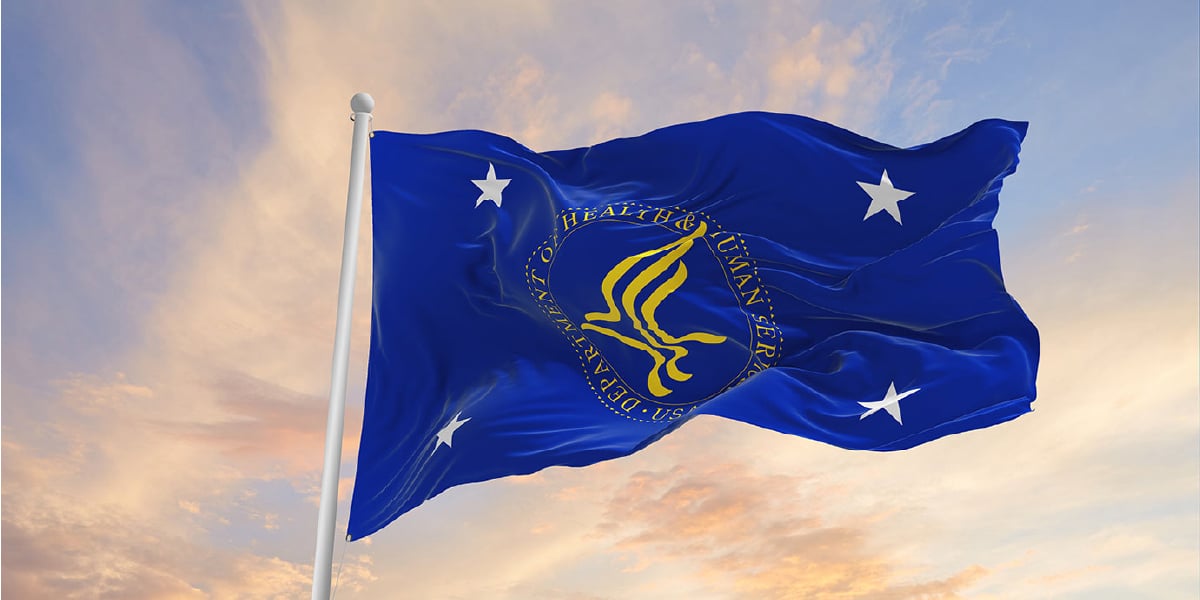 Blue flag with four white stars and the yellow U.S. Department of Health & Human Services seal in the center.