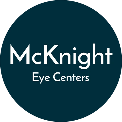 McKnight Eye Centers logo with white text on a dark circular background.